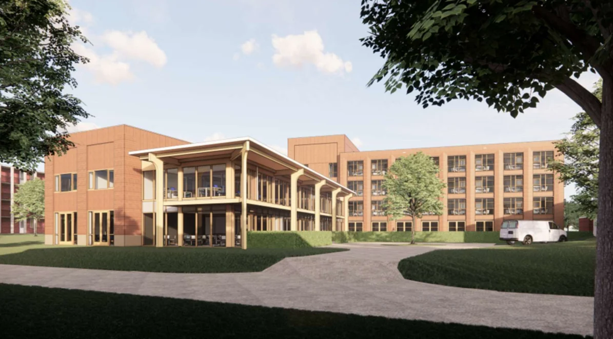 Moderne tweeledig gebouw met overdekt terras, gras en bestelwagen bij inrit op heldere dag